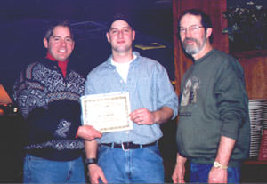 Dan hands diploma to student